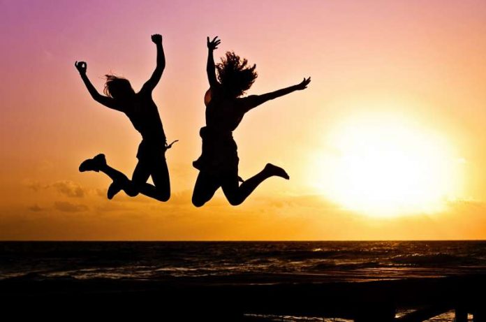 happy people jumping in the sunrise