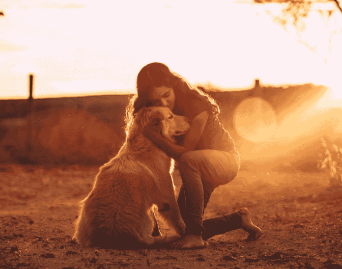 a woman hugging a dog